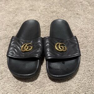 Gucci Black Slides with Gold Emblem